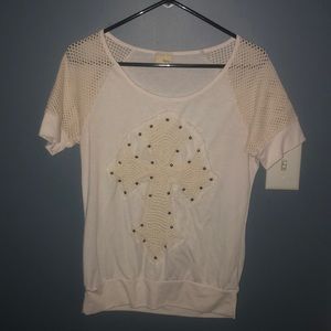 Cream color soft top with cross on front